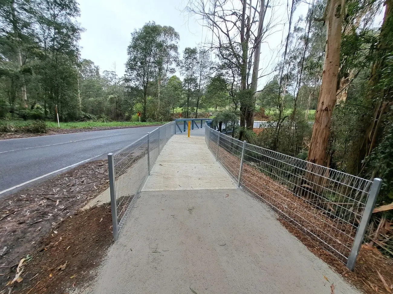 A newly tensioned galvanised chainwire fence running along a boundary