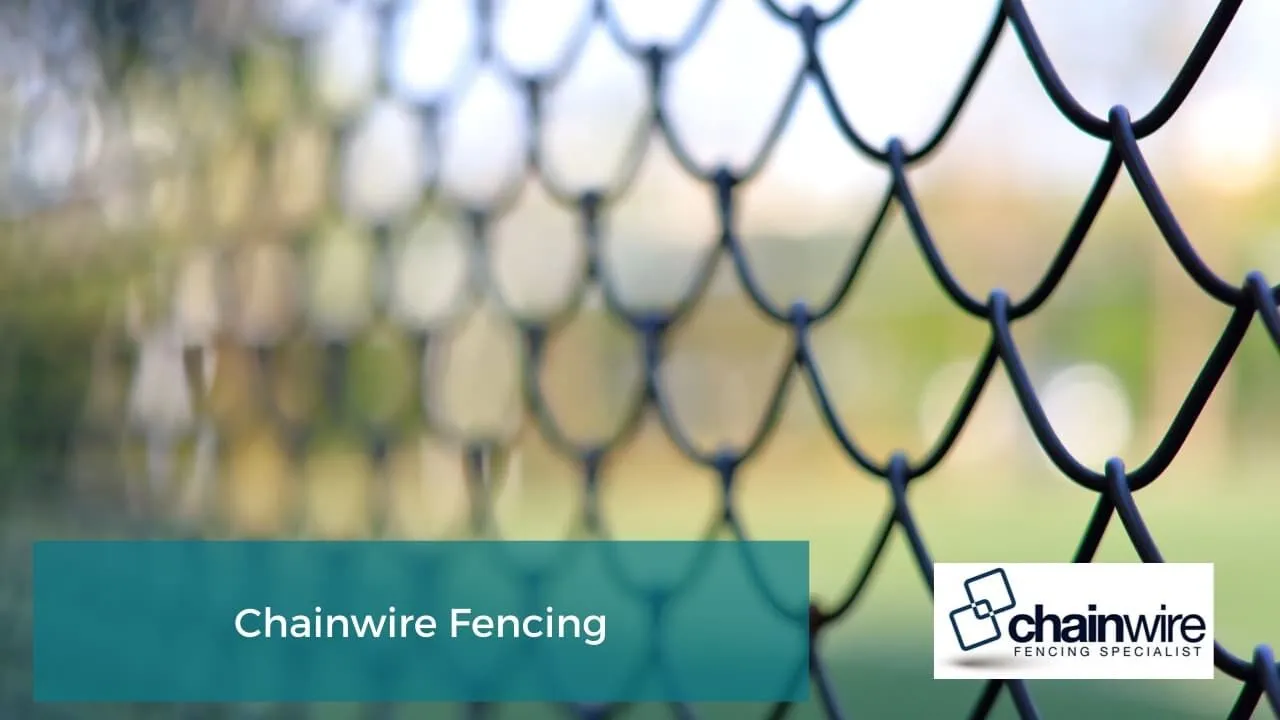 A galvanised chainwire fence securing a commercial property boundary