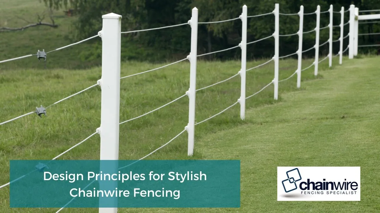 A black powder-coated chainwire fence blending into a landscaped garden