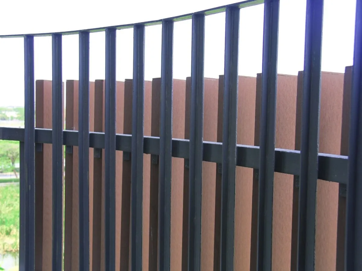 A dark metal internal partition fence dividing a work area.