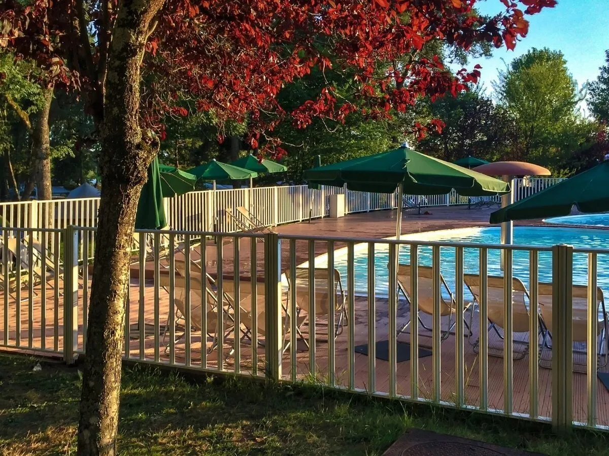 A compliant aluminium pool safety barrier around a backyard swimming pool
