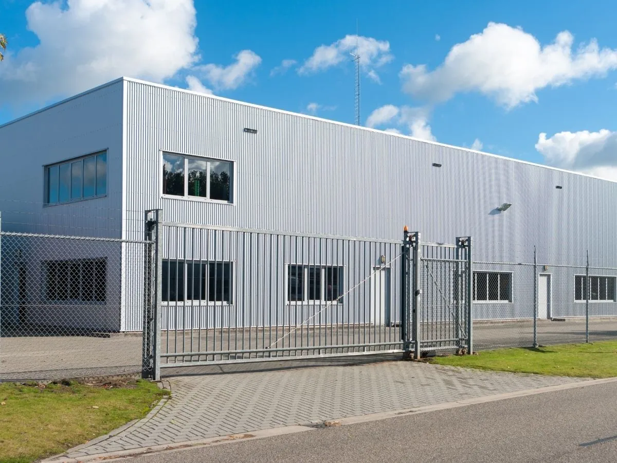 A commercial building with a metal sliding security gate across its frontage.