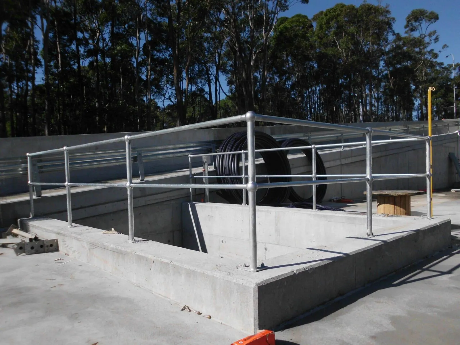 Galvanised pipe handrails fabricated from tube and cast fittings.