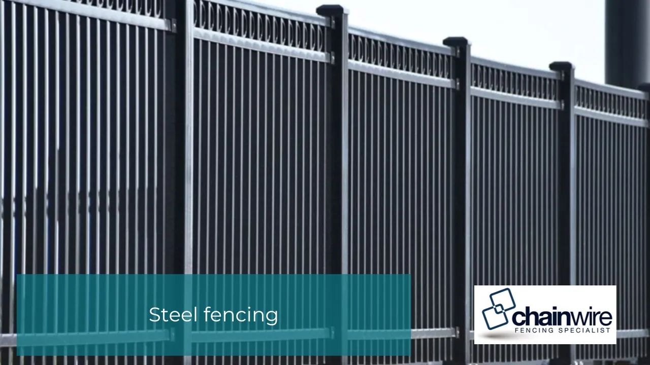 Steel fence and gate showing wear along a boundary