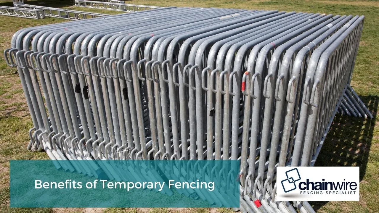 Temporary chainwire mesh fencing panels on portable feet around a work area