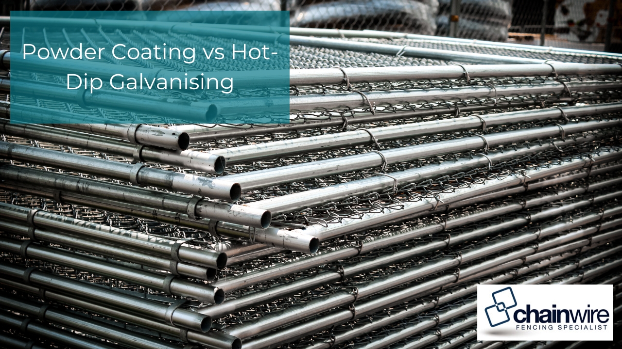 A large stack of galvanised chainwire fence panels and poles in a storage yard