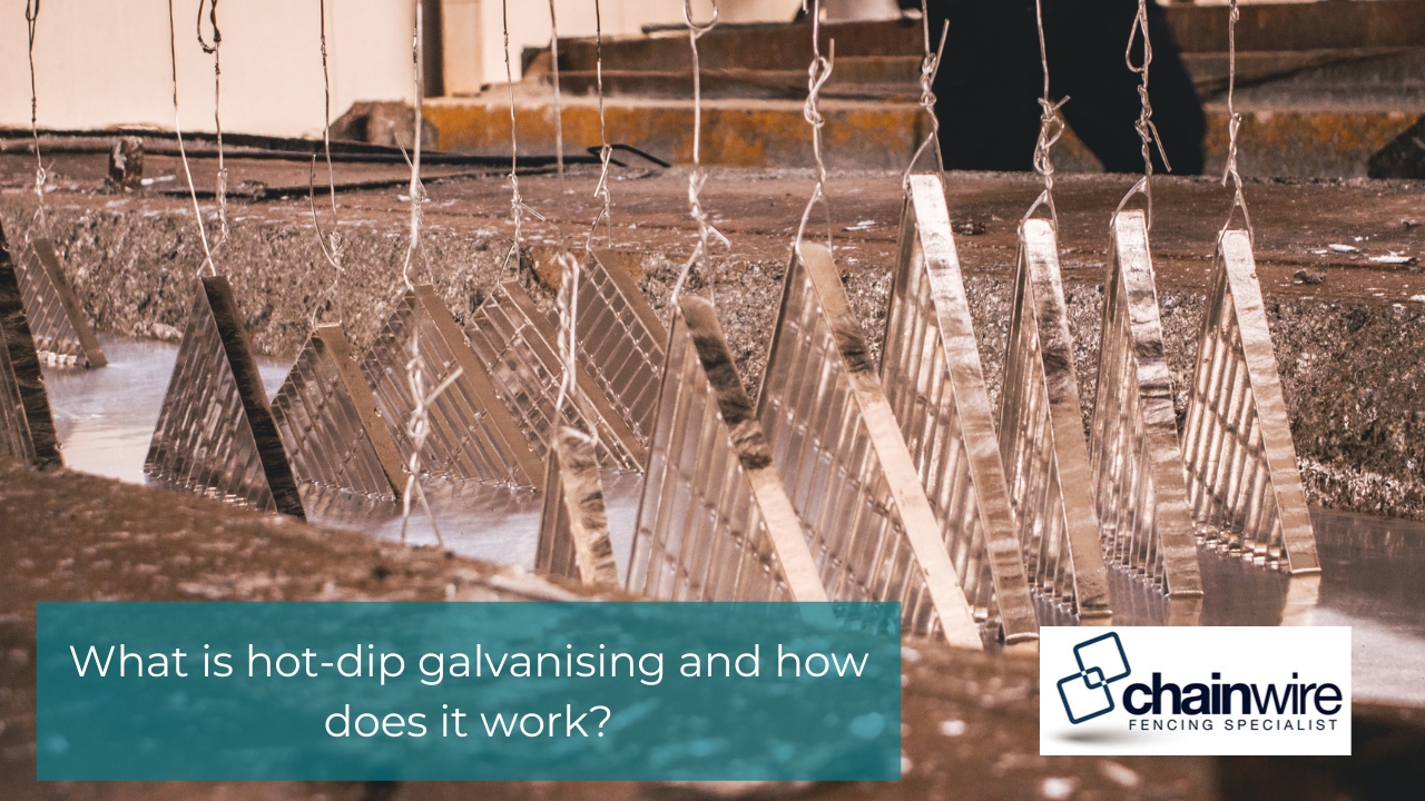 Powder Coating vs Hot-Dip Galvanising - Galvanising Steel grating panels hanging from wires as they are dipped into a hot-dip galvanising bath