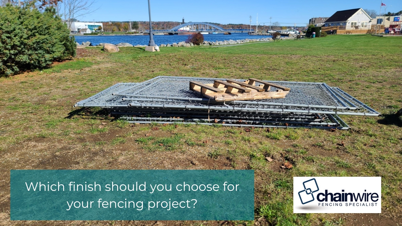Powder Coating vs Hot-Dip Galvanising - Galvanising Stack of galvanised chainwire fence panels laying on grass at a park or riverside location