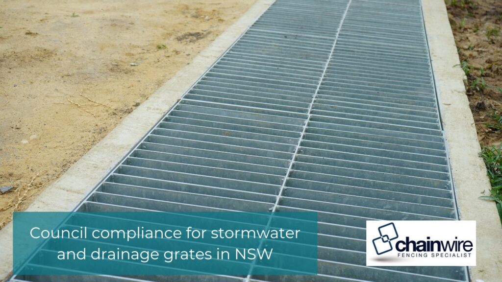 Industrial Grates and Drainage Covers: Materials, Sizing and Installation Explained - Steel Grates A long, galvanised steel grates set in a concrete channel next to dirt ground.