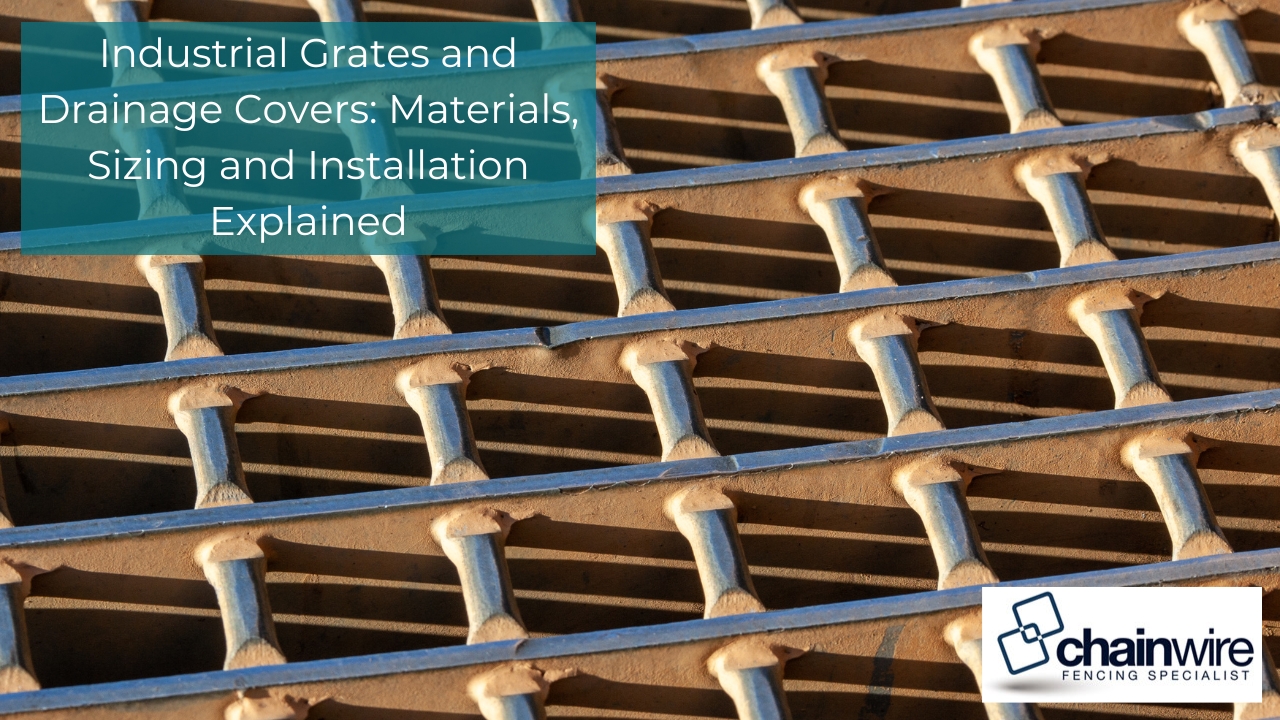 A heavy-duty metal industrial drainage grate catching the sunlight.